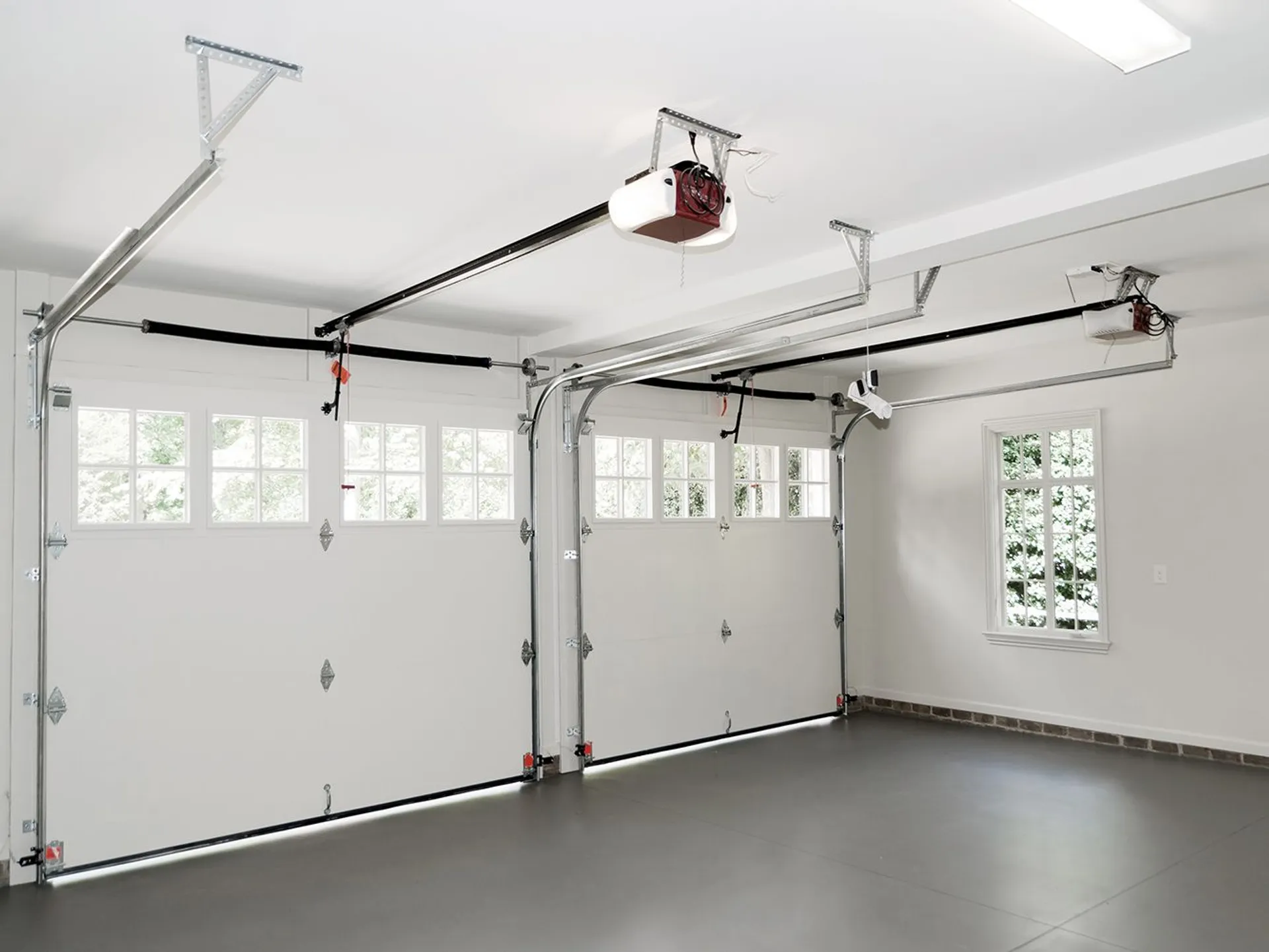 Two-story home with matching wood-tone garage doors