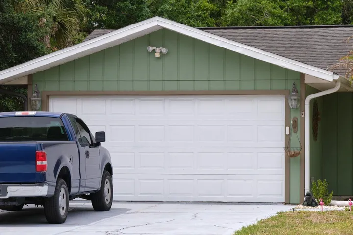 Single-story home with a two-car garage door and truck parked in the driveway in Glendale, AZ