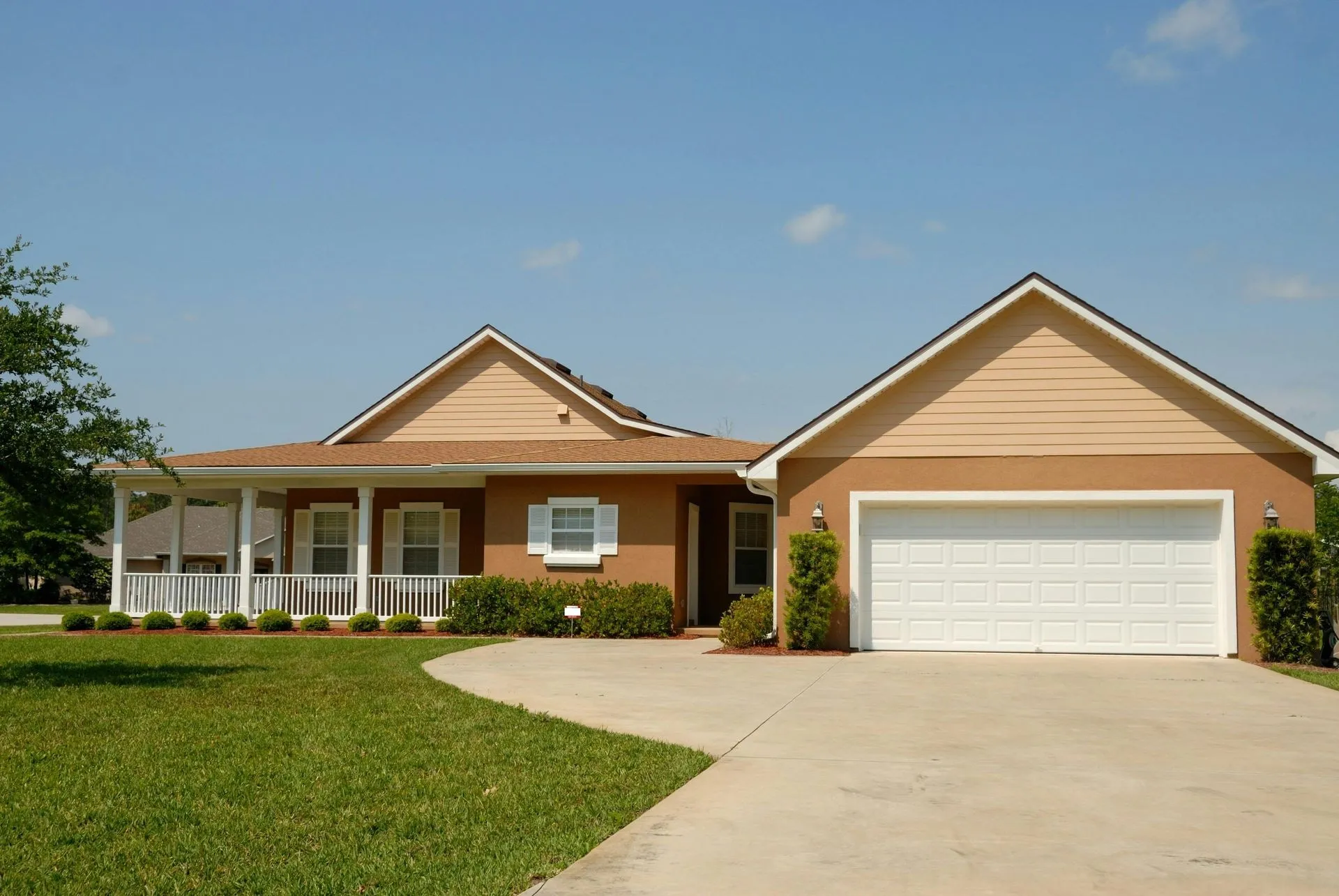 Single-story Sun City, AZ home with a covered porch and a white raised-panel double garage door
